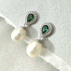 Personally Designed green Emerald and Freshwater Pearl Earrings perfect for special occasions, weddings and anniversary gift. Medium sized drop pearl earrings using carefully selected natural freshwater pearls with elongated shapes to compliment the emerald earrings, evening earrings for special occasions. Everyday drop earrings.  These classically designed earring are made with beautifully faced deep Green emerald and Teardrop shaped genuine Fresh Water Pearls. 💎 Material: Sterling Silver or 18K Yellow Gold Vermeil 💎 Gem Stone: AAA Freshwater Pearls, Green Emeralds with small clear topaz gemstones.  💎 Gemstone Shape: teardrop  💎 Total length 24mm drop  💎 Size of pearls: 7*10mm approximately, natural pearls are all individually unique, please allow slightly different sizes. I would do Classic Green Pear Shaped Earrings, Classic Green Pear-shaped Earrings, Gemstone Teardrop Earrings For Wedding, Wedding Gemstone Teardrop Earrings, Elegant Gemstone Earrings For Wedding, Wedding Teardrop Gemstone Earrings, Elegant Gemstone Wedding Earrings, Green Gemstone Bridal Earrings For Wedding, Green Pear-shaped Earrings For Formal Events