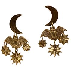 BATS!!!!!! These hand-hammered brass earrings features a Bat in flight against a celestial backdrop of the moon and stars. Perfect for the person who loves Bats, or Halloween, or both. Let it add a stylish and bold touch to your everyday look. Made here in Salem exclusively for us to go along with the Exhibition Bats! On view now through July 28, 2024. Brass with sterling silver posts. Nickel and lead free.2″ long. --- Made in Salem, Ma Jewelry Care General - Always remove jewelry and/or hair ac Bat Wing Earrings, Whimsigoth Accessories, Amanita Virosa, Bat In Flight, Whimsigoth Jewelry, Celestial Backdrop, Moon Accessories, Moon Earring, Bat Jewelry