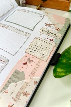 an open planner book sitting on top of a table