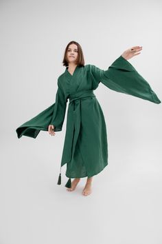 This exquisite Japanese kimono dress is the perfect gift for the woman in your life - whether it's your girlfriend or wife. Crafted from high-quality linen, this long jacket doubles as a coat, making it the ideal piece for any occasion. This organic loungewear piece boasts a maxi length and boho-inspired design, making it a stylish addition to any wardrobe. Embrace eco-friendly fashion with this minimalistic linen robe, offering both comfort and sustainability in one beautiful garment. Wrapped d Fitted Green Spring Kimono, Fitted Long Green Kimono, Long Sleeve Green Robe For Fall, Green Dresses For Tea Ceremony, Green Kimono With Kimono Sleeves For Tea Ceremony, Fitted Long Sleeve Green Kimono, Spring Green Wrap Kimono, Elegant Linen Kimono With Kimono Sleeves, Green Wrap Kimono For Fall