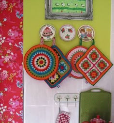 there are many different items on the wall in this room, including plates and pot holders