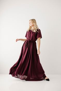 Elegant and feminine, the 'Alexandra' Maxi Dress is perfect for any dressy occasion! This dress features a modest crew neckline, flowy sleeves, a tie waistband and it is fully lined! Pair with wedge sandals for a wedding, a denim jacket and booties for a Sunday morning, or style with fun accessories for a photoshoot. The possibilities are endless! This beautiful dress was made exclusively with you in mind! Self & Lining100% Polyester Hand Wash Cold Do Not Bleach Lay Flat to Dry Low Iron if Needed Do Not Dry Clean Fully Lined Model Height 5'6" | Wearing Size Small Model Height 5'10" | Wearing Size 1X Please carefully measure a similar item before placing your order to allow for the best fit and also to reduce the risk of returns. Have questions about fit? Call us! We try everything on, so w Flowy Chiffon Maxi Dress With Tie Waist, Flowy Chiffon Dress With Tie Waist, Flowy Tie Waist Dress For Formal Occasions, Formal Flowy Dress With Tie Waist, Modest Midi Dress With Tie Waist, Formal Belted Flowy Dress, Modest Wardrobe, Burgundy Maxi Dress, Fun Accessories