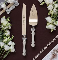 wedding cake knife and server set with flowers on the table next to it's name