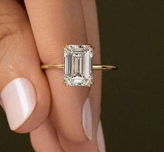 This lovely emerald-cut colorless moissanite diamond ring is enhanced in presence and brightness by technical craftsmanship and the concentric, rectangular rows of parallel facets. This design has a slim band that lets the simulated diamond, which has exceptional color and clarity, take center stage. Nothing conveys love quite like a diamond solitaire, which stands for one specific symbol of love. Emerald Ring, Gift For Women, Handmade Jewelry, Promise Matching Forever Ring For Her. ➡️ Ring Size Double Prong Emerald Cut Engagement Ring, Gia Certified Square Cut Moissanite Diamond Ring, Moissanite Emerald Cut Diamond Ring For Proposal, Diamond White Moissanite Emerald Cut Ring, Solitaire Moissanite Diamond Ring Emerald Cut, Moissanite Emerald Ring With Diamond Cut, Emerald Cut Moissanite Solitaire Diamond Ring, Radiant Cut Moissanite Emerald Ring With Prong Setting, Emerald Cut Moissanite Ring With Diamond Cut