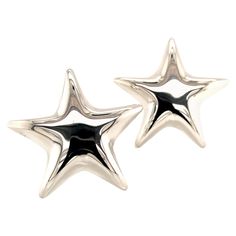 two silver stars with black spots on them are sitting next to each other in front of a white background