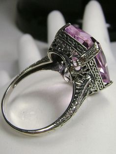 Simulated Pink Topaz Ring G Design#5 Custom Made Inspired by Edwardian era and Art Deco designs, I now offer this lovely filigree reproduction in sterling silver. This is a flawless Man-made/Simulated pink topaz is 15mm (5/8th of an inch) by 12mm (1/2 inch) in size. The inside of the band is etched 925. Notice the intricate and detailed design of the antique silver filigree setting all the way down the band. This is an exquisite rendition of an antique filigree ring.... and is ready to wear. A g Vintage Amethyst Ring With Accent Stones For Collectors, Vintage Amethyst Ring With Accent Stones, Antique Hallmarked Amethyst Wedding Ring, Victorian Topaz Ring With Accent Stones As Gift, Vintage Amethyst Ring With Intricate Design For Anniversary, Victorian Amethyst Ring With Accent Stones For Anniversary, Victorian Amethyst Ring With Accent Stones For Wedding, Vintage Amethyst Ring With Accent Stones For Wedding, Antique Amethyst Gemstone Ring For Wedding