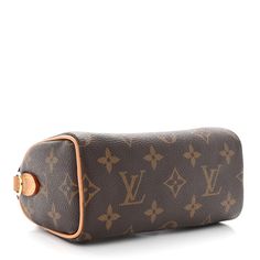 This is an authentic LOUIS VUITTON Monogram Nano Speedy Bandouliere. This stylish, petite handbag is crafted of Louis Vuitton monogram on coated toile canvas. The bag features rolled vachetta cowhide leather top handles with polished gold-toned links. The top zipper opens to a cocoa fabric interior. Nano Speedy, Stylish Petite, Speedy Bandouliere, Leather Top, Authentic Louis Vuitton, Cowhide Leather, Louis Vuitton Monogram, Cocoa, Gold Tones