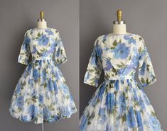 "Vintage 1950s cocktail party dress with a beautiful blue bold floral print throughout. This vintage dress features a very lovely flattering fitted bodice with a shelf bust fit, defined nipped waist, and full skirt. Back metal zipper for closure.  ✂------ M E A S U R E M E N T S -------  Best Fit: Small Bust: 34\" Waist: 26\" Hips: open fit Shoulders: undefined  Sleeves: 13\" Total Length: 39.5\" Material: chiffon Condition: Excellent vintage condition. Ready to wear.   ☆ Layaway is available fo Retro Blue Dresses For Vintage Events, Retro Blue Dress For Vintage Events, Blue Vintage Dress For Spring Wedding, Retro Floral Print Cocktail Dress, Vintage Dress With Lined Bodice For Garden Party, Fitted Blue Vintage Dress For Wedding, Blue 1950s Fitted Vintage Dress, Blue Fitted Vintage Dress For Vintage Occasions, Blue Vintage Dress With Fitted Bodice