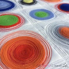 a close up of a quilt with circles on it