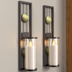 two wall mounted candles are next to each other