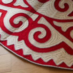 a red and white quilt on the floor