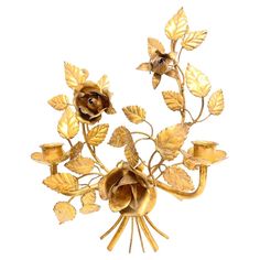 an image of a brooch with flowers and leaves on it's back side