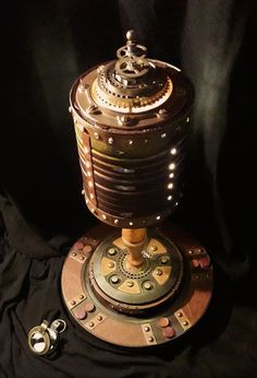 an old fashioned clock sitting on top of a black cloth