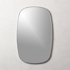 an oval mirror on the wall is shown