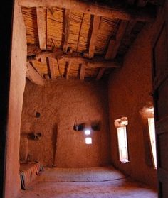 the interior of an adobe - style building with stone floors