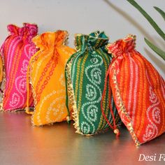 Bandhini is a beautiful fabric that requires hand-crafted skills. About a thousand years old, bandhini cloth involves a long process that can only be done by skilled artisans at by hand, producing beautiful dotted patterns. These bandhini potlis by Desi Favors will win your heart and turn heads at any and every occasion. * Set of 4 colorful potlis that are perfect for return gifts during festivals or weddings * Each potli bag is 9x7 inches in size * Comes in four vibrant colors of pink, green, r Bride Fashion Photography, Indian Wedding Favors, Diy Diwali Decorations, Desi Wedding Decor, Potli Bag, Indian Gifts, Bridal Mehendi Designs, Diy Bags Patterns, Return Gifts