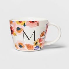 a floral mug with the letter m on it