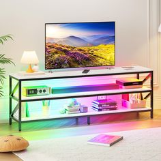 a television on a stand in a living room with a colorful light coming from the screen