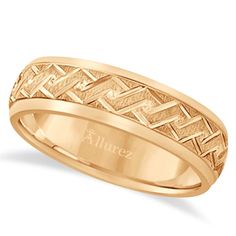 an 18k yellow gold wedding band with intricate design on the outside and inside, is shown