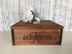 a wooden box with flowers on top