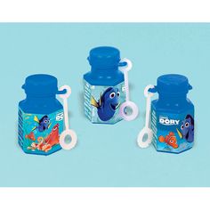 three blue plastic containers with finding nemo on the lids and one is holding a toothbrush