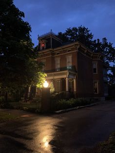 an old house lit up at night with its lights on