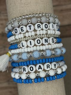 the bracelets are decorated with beads and tassels that read detroit lions roar