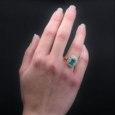 This is part of Chairish’s Fine Jewelry assortment.  Ring in 18 karat yellow gold, and platinum.  Elegant and timeless antique ring, it presents a rectangular frame decorated in the center of a degrees- cut emerald in closed setting, and surrounded by modern brilliant- cut diamonds.  The basket is openwork to let the light pass under the gems.  Weight of the emerald : 1.60 carat approximately.  Emerald certified Colombian by the French laboratory of Gemmology.  Total weight of the diamonds : 0.8 Classic Platinum Gemstones Gia Certified, Classic Gia Certified Platinum Gemstones, Gia Certified Platinum Classic Gemstones, Classic Platinum Gemstones With Halo Setting, Classic Diamond Gemstone With Center Stone, Fine Jewelry Diamond Cluster Gemstones, Gia Certified Diamond Gemstones For Anniversary, Luxury Emerald Cluster Ring With Vvs Clarity, Emerald Cut Diamond Fine Jewelry