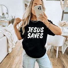 This Jesus Saves Shirt is the perfect way to share a bold faith statement with others in a fashion-forward way. This trendy Christian graphic tee with bold message that Jesus saves, is sure to turn heads! It's the perfect combination of faith and fashion to create a trendy Christian street style or casual chic outfit that makes a bold statement! Wearing Christian apparel like this Jesus tee, is an intentional way to proclaim your faith and create opportunities to share Jesus with others. If you’ Inspirational Graphic Print Top For Streetwear, Create Opportunities, Bold Faith, Christian Graphic Tees, Patriotic Outfit, Christian Apparel, Jesus Saves, Oversized Style, Casual Chic Outfit