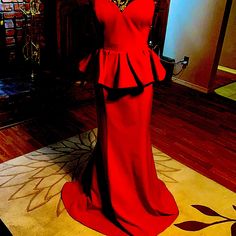 a mannequin dressed in a red dress on display