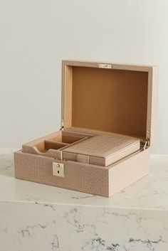 an open box sitting on top of a marble counter next to a white wall and floor