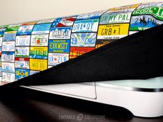 a close up of a keyboard on a desk with many stickers all over it