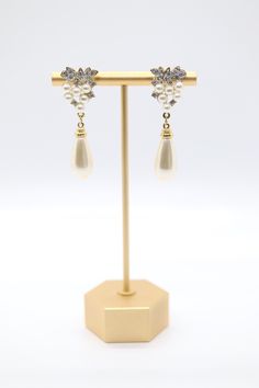 These pearl drop earrings are a classic design that will never go out of style. The earrings are made with genuine freshwater pearls and cubic zirconia accents. The pearls are a creamy white color and have a beautiful luster. The earrings are very lightweight and comfortable to wear. The pearl drops are about an inch long, and the earrings are about 1.5 inches long overall. The Pearl, Pearl Drop Earrings, Tennis Bracelet, Pearl Drop, Creamy White, Christmas Sale, Go Out, Out Of Style, Desk Lamp