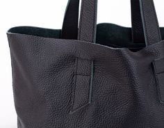 "The Calisto tote bag in Black soft pebbled cow leather. This unlined leather purse is a great tote and then some! With its simple yet fashionable design, it will carry all your daily essentials and is perfect for those weekend getaways or trips to the gym. Inside the bag, there is a set of two pockets measuring 8\" x 5\" (21 x 12 cm) and 8\" x 6\" (21 x 15 cm) and a key clip attached to a long leather strip. Aprox. dimensions: 13\" x 12.5\" x 5.5\" (33 x 32 x 14cm).Top opening 18.5\" (47cm).Str Textured Leather Tote Satchel For Daily Use, Daily Use Textured Leather Satchel Tote, Daily Use Textured Leather Tote Satchel, Rectangular Textured Leather Hobo Bag For Everyday Use, Everyday Use Smooth Grain Hobo Tote Bag, Everyday Textured Leather Tote Hobo Bag, Minimalist Shoulder Bag With Rolled Handles For Shopping, Minimalist Everyday Bag With Rolled Handles, Daily Use Tote Shoulder Bag With Smooth Grain