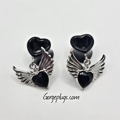 🖤You'll Receive One Pair Of These Drop/ Dangle Tunnels: All Silver Finish With Black Gem Inside An Angel Wings & Heart Pendant. Tunnels Were Designed To Be Hider Gauges For Work Or For Any Occasion Your heart desires. We Specialize In Gorgeous Jewelry For Stretched Ears. 🖤MATERIALS USED VARIES DEPENDING ON YOUR PLUG SIZE! ↓ Sizes 0g-1/2": Will Be Done In ACRYLIC DOUBLE FLARED Tunnels ◼️Sizes Available Are 0g (8mm) , 00g (10mm), 1/2"(12mm)9/16" (14mm), 5/8 (16mm), 3/4 (18mm), 13/16" (20mm), 7/8 Black Heart Earrings For Pierced Ears As Gift, Black Heart Earrings As A Gift, Nickel-free Black Plug Earrings As Gift, Wing-shaped Black Jewelry Gift, Black Wing-shaped Jewelry Gift, Wing-shaped Black Jewelry For Gifts, Black Wing-shaped Jewelry For Gifts, Gift Black Jewelry With Wing-shaped Pendant, Black Sterling Silver Heart Earrings