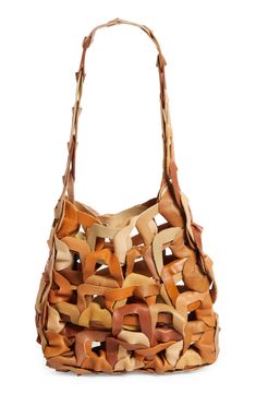 A meticulous web of interlaced circles made from scrap calfskin leather forms this one-of-a-kind signature tote that blurs the lines between art and accessory. Due to the handmade nature of the manufacturing process and the source materials, the exact color and pattern placement may vary with each piece. Open top Shoulder strap Handcrafted Unlined Leather Made in the USA SPACE: A shop for emerging and advanced designers Brown Leather Bucket Bag With Intrecciato Weave, Designer Leather Bags With Interwoven Design, Modern Leather Shoulder Bag With Interwoven Design, Natural Leather Bag With Interwoven Design, Brown Leather Shoulder Bag With Interwoven Design, Brown Leather Bags With Interwoven Design, Woven Leather Bucket Hobo Bag, Woven Leather Bucket Bag Tote, Designer Natural Leather Shoulder Bag