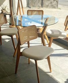 a glass table with chairs around it