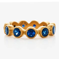 a gold ring with blue stones on it