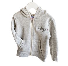 Fleece lined full zip-up hoodie. All styles include custom embroidery with your choice of phrase, font, thread color + text placement. Please make selections below. Material Content: 50% polyester, 37% ringspun cotton, 13% rayon Mockups provided upon request, please contact us. Click here for embroidery ideas *Style runs true to size, when in doubt size up :) ﻿Matches Little Kids Zip-Up Fleece Hoodie , Big Kids Zip-Up Fleece Hoodie, + Adult Zip-Up Fleece Hoodie Baby Denim Jacket, Kids Denim Jacket, Baby Tie, Kids Tie Dye, Color Text, French Terry Hoodie, Baby Pajamas, Toddler Hoodie, Kids Denim