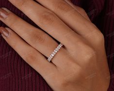 a woman's hand with a diamond ring on it