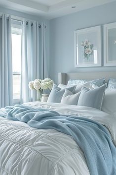 a bedroom with blue walls and white bedding