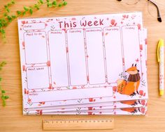 this week planner is sitting on top of a desk next to a pen and glasses