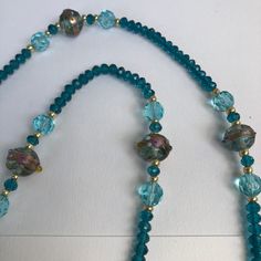 Victorian or 20's style Long Handmade Turquoise Blue Lamp Work WEDDING CAKE bead NECKLACE with deep turquoise or teal blue faceted glass beads and gold glass spacers. THE BEADS ARE TRADITIONALLY CALLED WEDDING CAKE BEADS AS THEY LOOK LIKE THEY HAVE BEEN PIPED WITH ICING (FROSTING). THEY ARE HANDMADE AND SET OFF WITH TONING GLASS BEADS. LENGTH OF NECKLACE...36.INCHES (90cm) AS SHOWN.... I CAN SHORTEN IT IF WANTED.  I AM LISTING OTHER COLOUR WEDDING CAKE BEAD NECKLACES BOTH LONG AND SHORT , I AM L Colour Wedding, Icing Frosting, Deep Turquoise, Blue Lamp, Bead Necklaces, 20s Fashion, Bleu Turquoise, Bead Stringing, Gold Glass