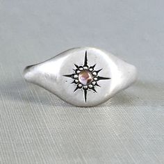 Star Signet Ring with Peach Pink Sapphire Oval Silver Signet Ring For Promise, Sterling Silver Star Shaped Signet Ring For Anniversary, Sterling Silver Star-shaped Signet Ring For Gift, Celestial Silver Signet Ring, Silver Signet Ring With Birthstone, Gift, Celestial Sterling Silver Signet Ring For Anniversary, Silver Celestial Signet Ring As Gift, Silver Celestial Style Signet Ring For Gift, Celestial Silver Signet Ring For Gift