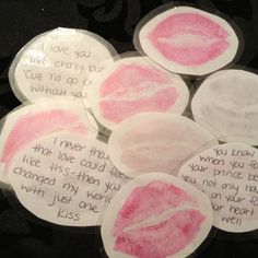 some pink and white stickers with writing on them