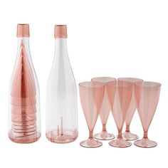 a set of four wine glasses and a bottle