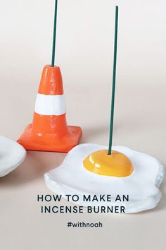 an egg sitting on top of a white plate next to a traffic cone with the words how to make an inconse burner