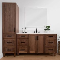 a bathroom with two sinks and a large mirror on the wall next to a wooden cabinet