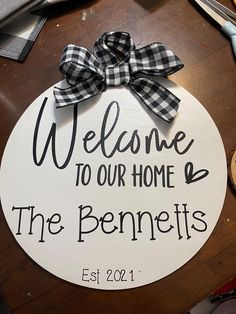 a welcome sign with a bow on top of it that says, welcome to our home the benniets