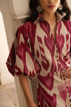 De Castro showcases a seamless and unique blend of traditional Indian craftsmanship, contemporary design, and the founder’s Colombian heritage. Every piece is handmade by artisans, using time-honored techniques and the finest cotton and silk fibers, resulting in exceptional quality, sustainability, and style. Crafted in sumptuous, handwoven silk ikat, the Burgundy Jodhpur Dress is cut with a fitted body, and boasts a collared neckline as well as delightful, ballon sleeves. Product Details 100% s Ikat Outfits Style, Cotton Stylish Dresses, Collar Dress Design, Unique Ethnic Wear Indian, Formal Indian Wear For Women, Women Dress Design Style, Ikat Dress Designs, Silk Dresses Indian, Business Dress Outfits